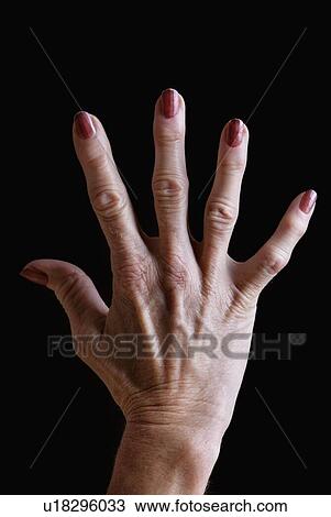 Senior woman's hand with red nail polish against black background View Large Photo Image Stock Image - Senior woman's hand with red nail polish against black background. Fotosearch