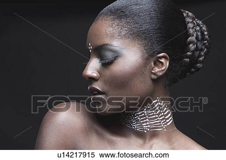 Stock Photography - Sensuous African American woman with eyes closed over black background. Fotosearch