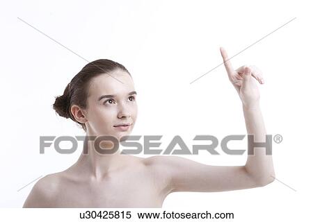 Shirtless beautiful young woman pointing up against white background View Large Photo Image Stock Photography - Shirtless beautiful young woman pointing up against white background. Fotosearch