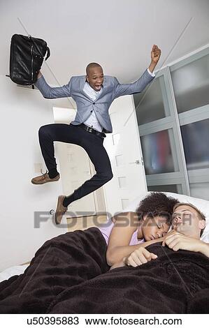 Shocked businessman looking at couple sleeping in bed View Large Photo Image Stock Image - Shocked businessman looking at couple sleeping in bed. Fotosearch
