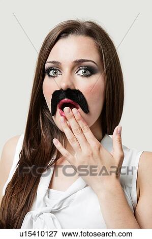 Shocked Woman wearing fake moustache View Large Photo Image Stock Photo - Shocked Woman wearing fake moustache. Fotosearch