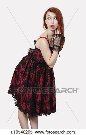 Shocked young woman in retro styled lace dress against gray background View Large Photo Image Stock Photography - Shocked young woman in retro styled lace dress against gray background. Fotosearch