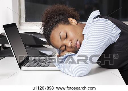 Side view of exhausted businesswoman with head on laptop in office View Large Photo Image Stock Photo - Side view of exhausted businesswoman with head on laptop in office. Fotosearch