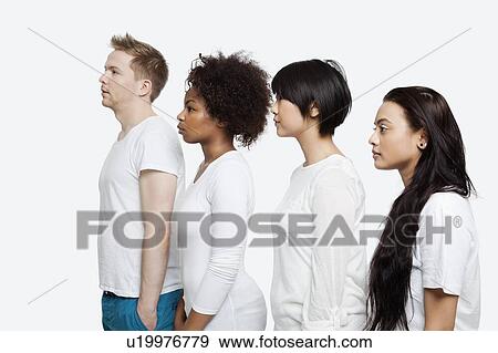 Stock Photo - Side view of young multi-ethnic friends in casuals standing in line over white background. Fotosearch