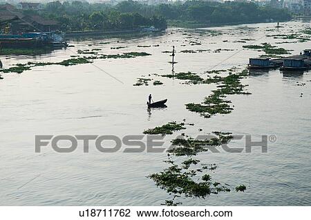 Stock Image - Small Boats and Barges on River. Fotosearch