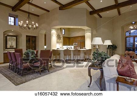 Stock Image - Spacious living room with dining table with bar counter in luxury villa. Fotosearch