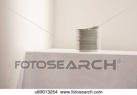 Picture - Stack of plates and cutlery on table. Fotosearch