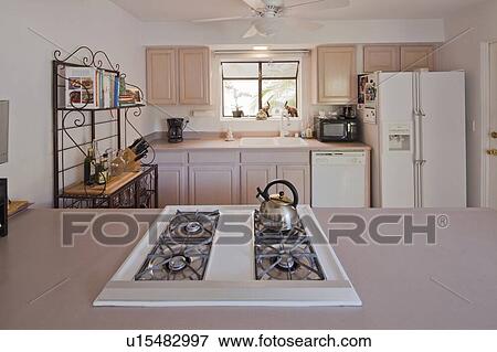 Stock Photo - Stove top and kitchen bench in traditional kitchen. Fotosearch