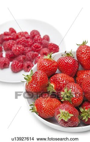 Picture - Strawberries and raspberries over white background. Fotosearch