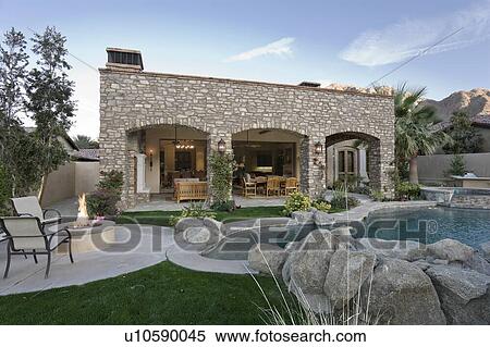 Stock Photography - Swimming pool in foreground of luxury villa. Fotosearch