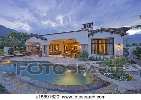 Stock Image - Swimming pool in front of luxury mansion. Fotosearch