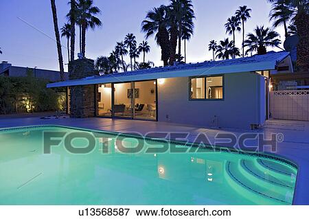 Swimming pool in front of luxury mansion View Large Photo Image Stock Photo - Swimming pool in front of luxury mansion. Fotosearch