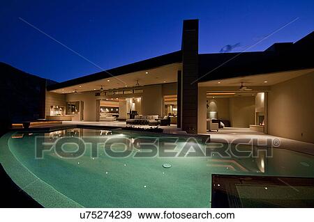 Swimming pool in front of luxury residential house View Large Photo Image Stock Photo - Swimming pool in front of luxury residential house. Fotosearch