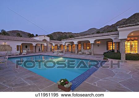 Stock Photography - Swimming pool in luxurious villa in evening. Fotosearch