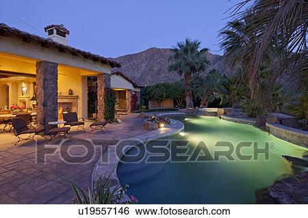 Swimming pool in luxury villa at evening with mountain in background View Large Photo Image Stock Photograph - Swimming pool in luxury villa at evening with mountain in background. Fotosearch