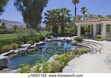 Picture - Swimming pool of luxury villa with mountain in background. Fotosearch