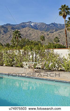 Stock Image - Swimming pool of mansion with view of mountains. Fotosearch