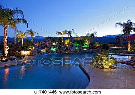 Stock Photograph - Swimming pool outside luxurious mansion. Fotosearch