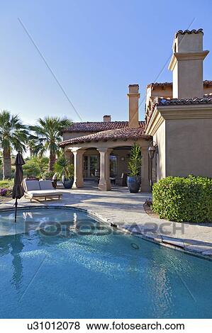 Swimming pool outside luxury mansion View Large Photo Image Stock Photo - Swimming pool outside luxury mansion. Fotosearch
