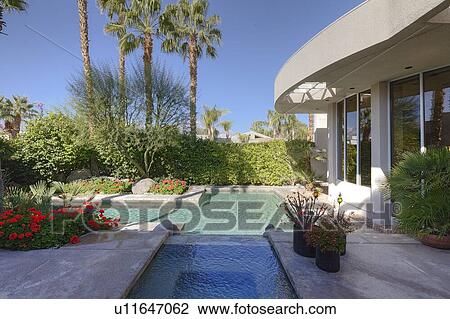 Stock Image - Swimming pool outside villa. Fotosearch