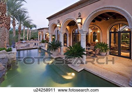 Stock Image - Swimming pool with patio of luxury villa. Fotosearch