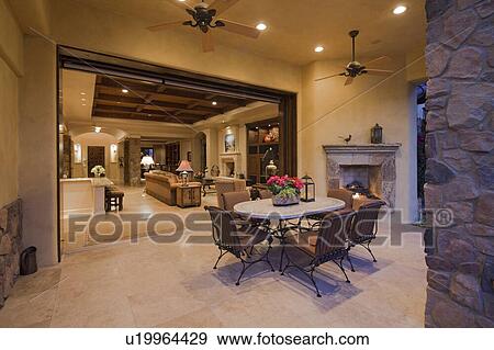 Table and chair in patio with living room in background View Large Photo Image Stock Photo - Table and chair in patio with living room in background. Fotosearch