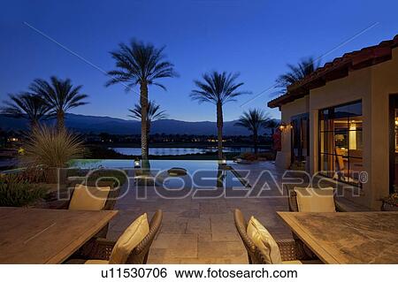 Table and chair in poolside patio of luxury villa View Large Photo Image Stock Photograph - Table and chair in poolside patio of luxury villa. Fotosearch