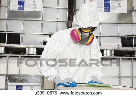 Technician in hazmat suit reading instructions on paper View Large Photo Image Stock Photography - Technician in hazmat suit reading instructions on paper. Fotosearch