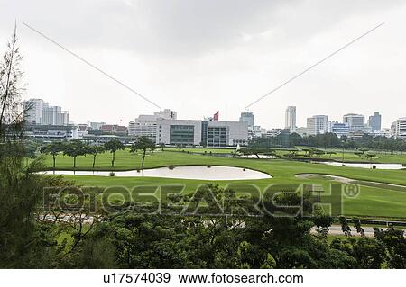 Stock Photo - The 18 hole golf course at Royal Bangkok Sports Club in the middle of Bangkok City; Thailand. Fotosearch
