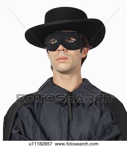 Thoughtful young man dressed as Zorro against gray background View Large Photo Image Stock Photo - Thoughtful young man dressed as Zorro against gray background. Fotosearch