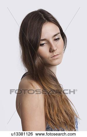 Thoughtful young woman over white background View Large Photo Image Stock Photograph - Thoughtful young woman over white background. Fotosearch