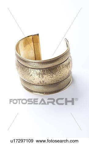 Trendy gold bracelet over white background View Large Photo Image Stock Photo - Trendy gold bracelet over white background. Fotosearch