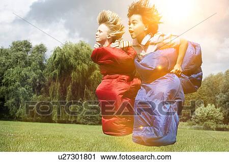 Two boys racing in sleeping bags View Large Photo Image Stock Image - Two boys racing in sleeping bags. Fotosearch
