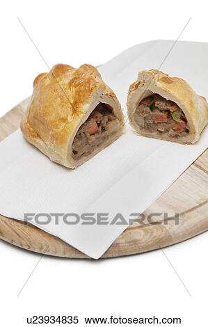 Two pieces of Cornish pastry and tissue on wooden plate View Large Photo Image Stock Photography - Two pieces of Cornish pastry and tissue on wooden plate. Fotosearch