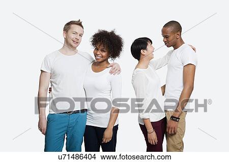 Two young couples in casuals standing together over white background View Large Photo Image Picture - Two young couples in casuals standing together over white background. Fotosearch