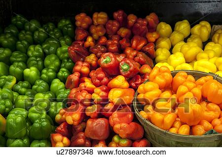 Stock Photo - Variety of bell peppers on display for sale in market. Fotosearch
