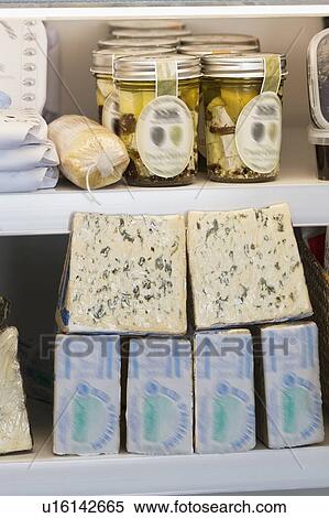 Variety of cheese blocks and jars on shelf View Large Photo Image Stock Photography - Variety of cheese blocks and jars on shelf. Fotosearch