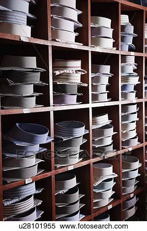 Stock Photography - Variety of shirts arranged on shelves in a clothing store. Fotosearch