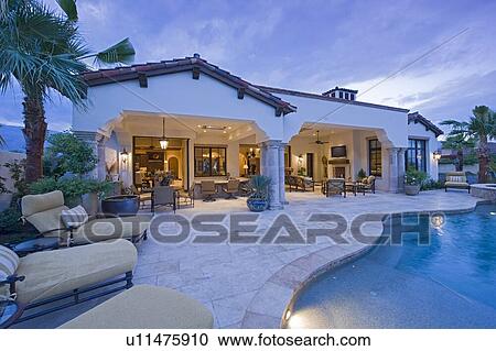 View of chaise lounges at poolside of luxury mansion View Large Photo Image Stock Image - View of chaise lounges at poolside of luxury mansion. Fotosearch