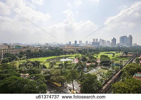 Stock Photo - View of golf course and city skyline; Manila; Philippines. Fotosearch