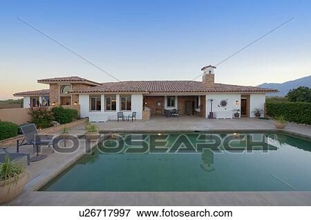Stock Photo - View of luxurious villa with swimming pool in foreground. Fotosearch