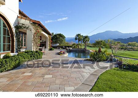 Stock Image - View of mountains and swimming pool from luxury manor house. Fotosearch