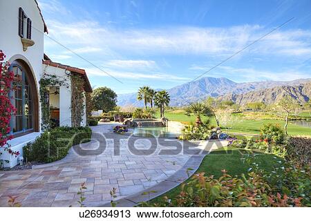 Stock Image - View of mountains from luxury manor house. Fotosearch