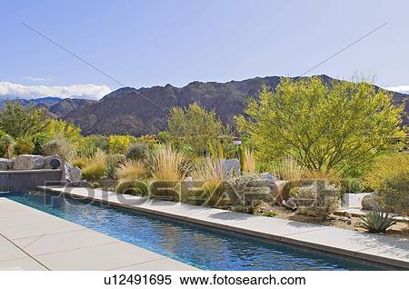 Stock Photography - View of mountains from patio of luxury manor house with small pool. Fotosearch