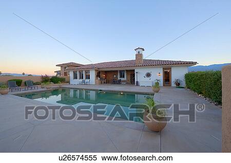 Stock Photography - View of pool and bungalow exterior. Fotosearch