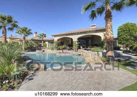 Stock Photo - View of swimming pool in luxury manor house. Fotosearch
