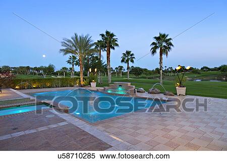Stock Photography - View of swimming pool with lawn in background. Fotosearch