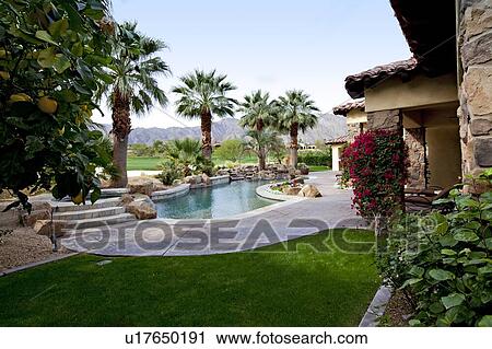 Stock Image - View of swimming pool with mountains in background. Fotosearch