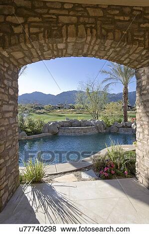 Stock Photo - View of swimming pool with mountains in background from luxury villa. Fotosearch