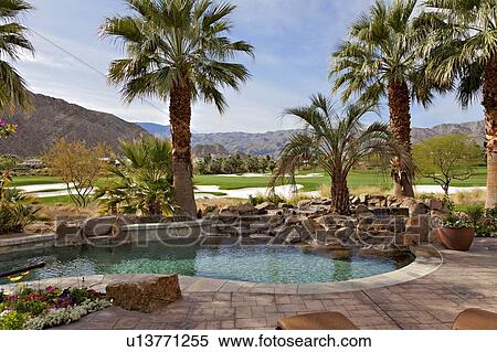 Stock Photography - View of swimming pool with private golf course in background. Fotosearch